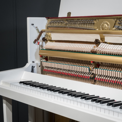 Yamaha U2H upright piano interior close-up, white case with gold plate and hammers