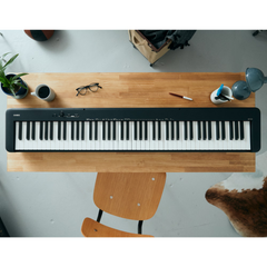 Casio CDP-S110 slim digital piano in black, top-down view on a desk