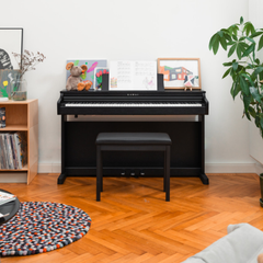 Kawai CX202 digital piano in satin black, in a living room with matching bench