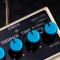 BOSS DD-3T digital delay pedal top close-up, blue feedback, time and mode knobs