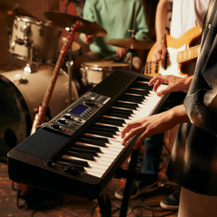 Musician playing a Casio Casiotone CT-S500 keyboard with a band at rehearsal