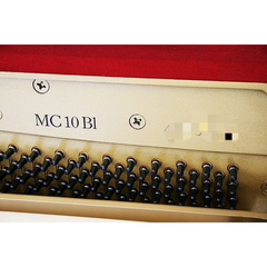Yamaha MC10BL upright interior close-up showing MC 10 Bl model stamp and tuning pins