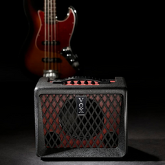 Vox VX50BA bass amp on stage with sunburst bass guitar in soft spotlight